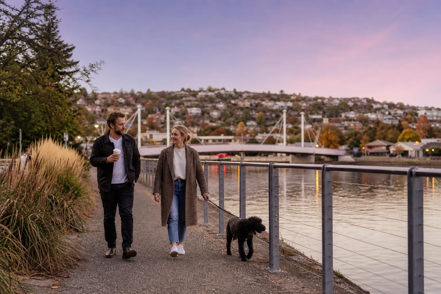 Two people talking over coffee at an outdoor table in central Launceston